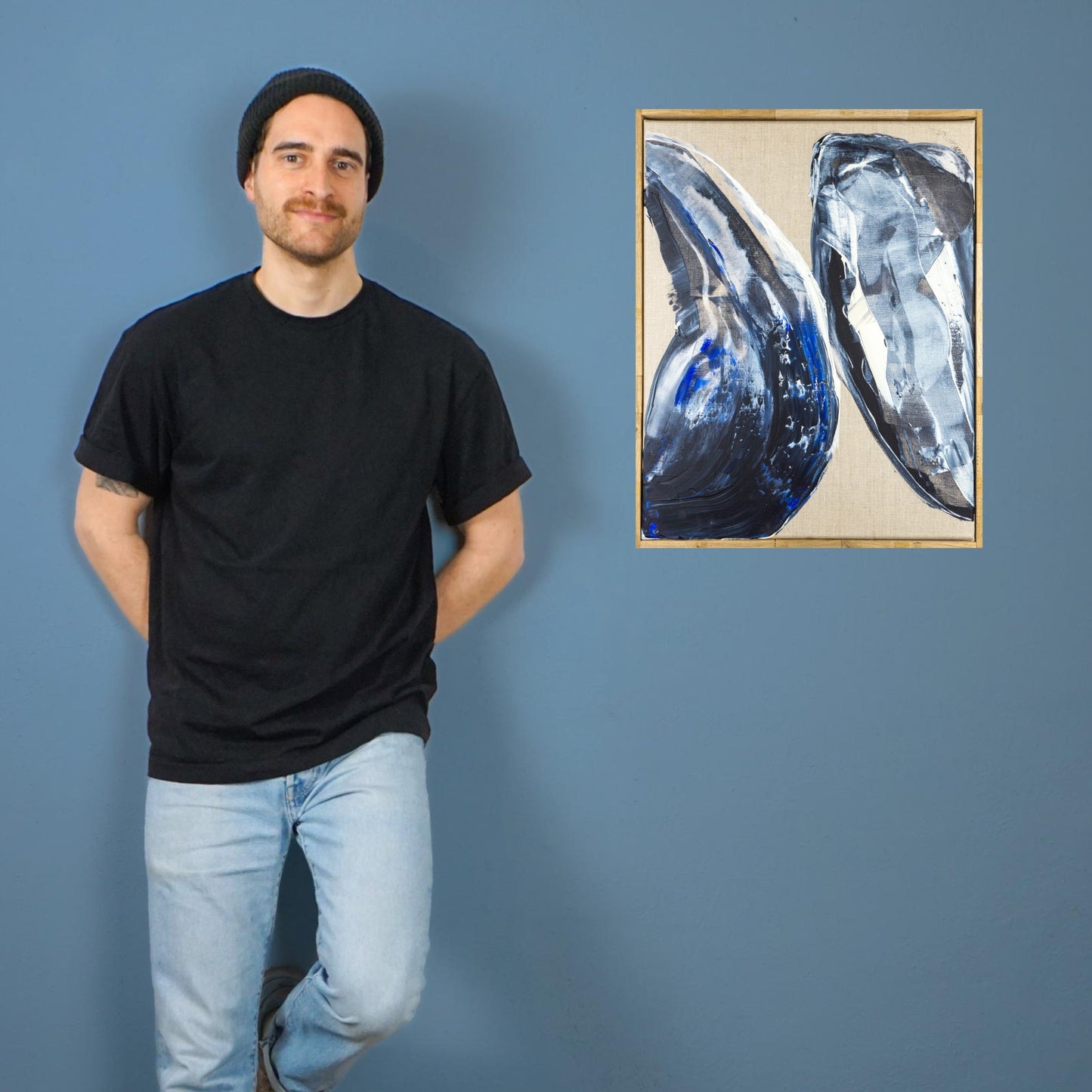 Max Lanzinger next to abstract modern painting.