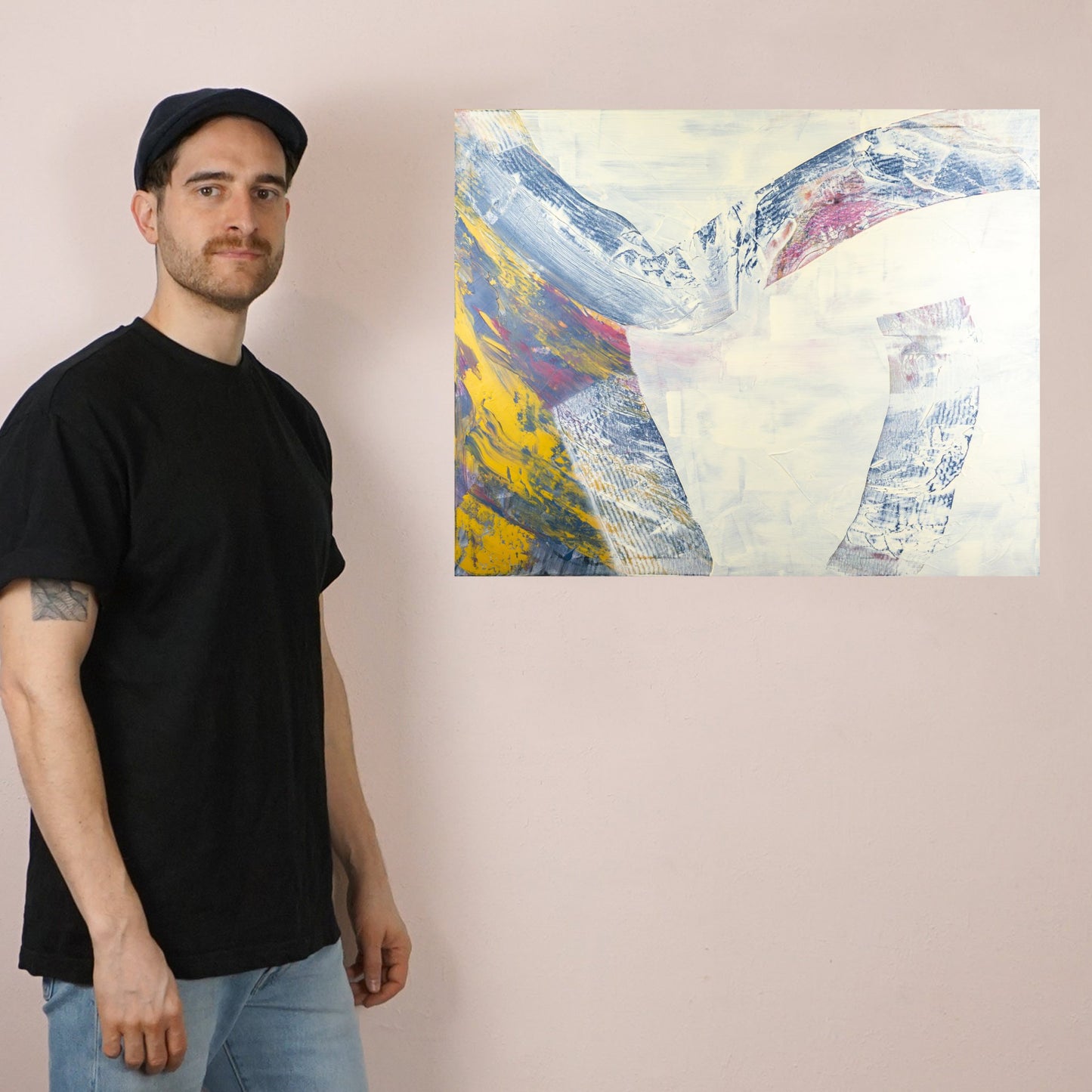 Max Lanzinger standing next to a fine art print.