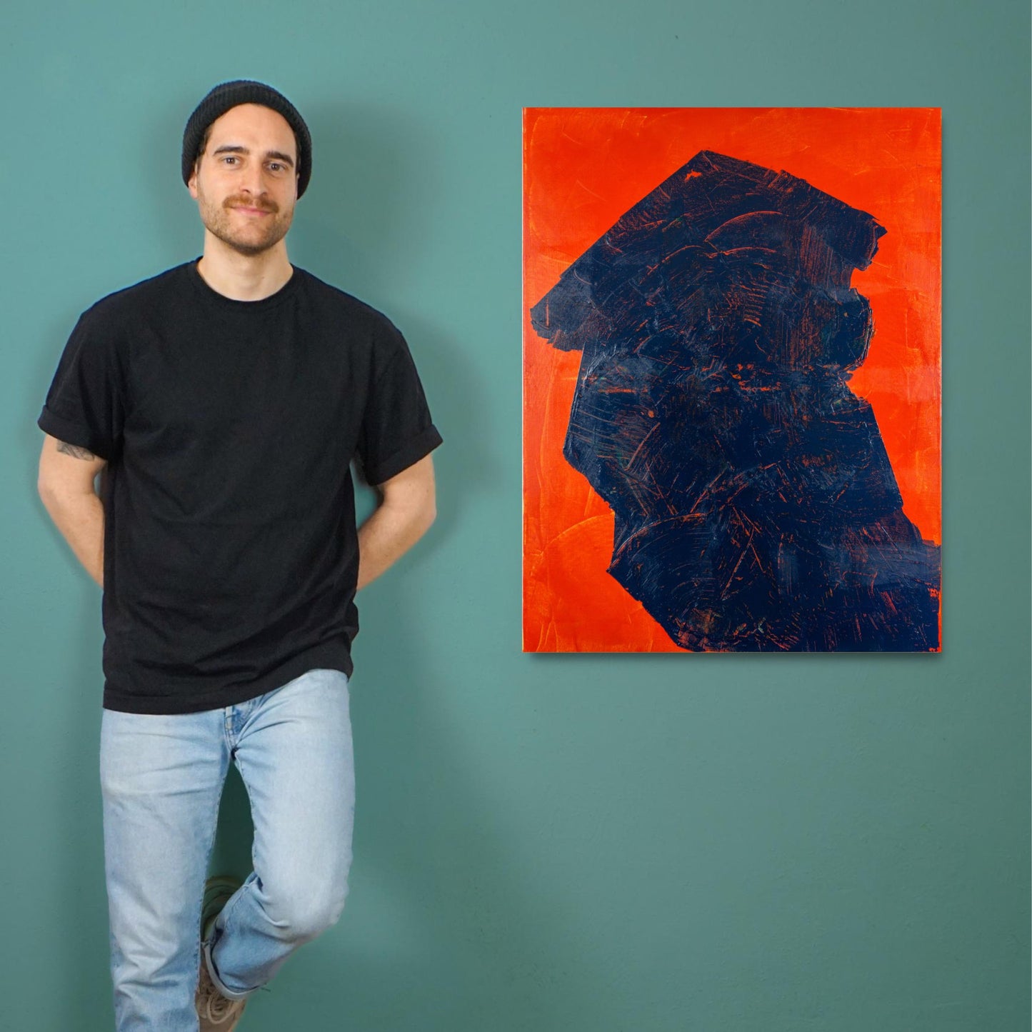 Artist Max Lanzinger standing next to his abstract painting with a Japanese-looking shape.